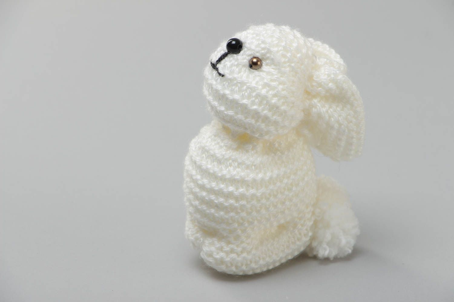 Handmade small soft toy knitted of white acrylic threads in the shape of rabbit photo 2