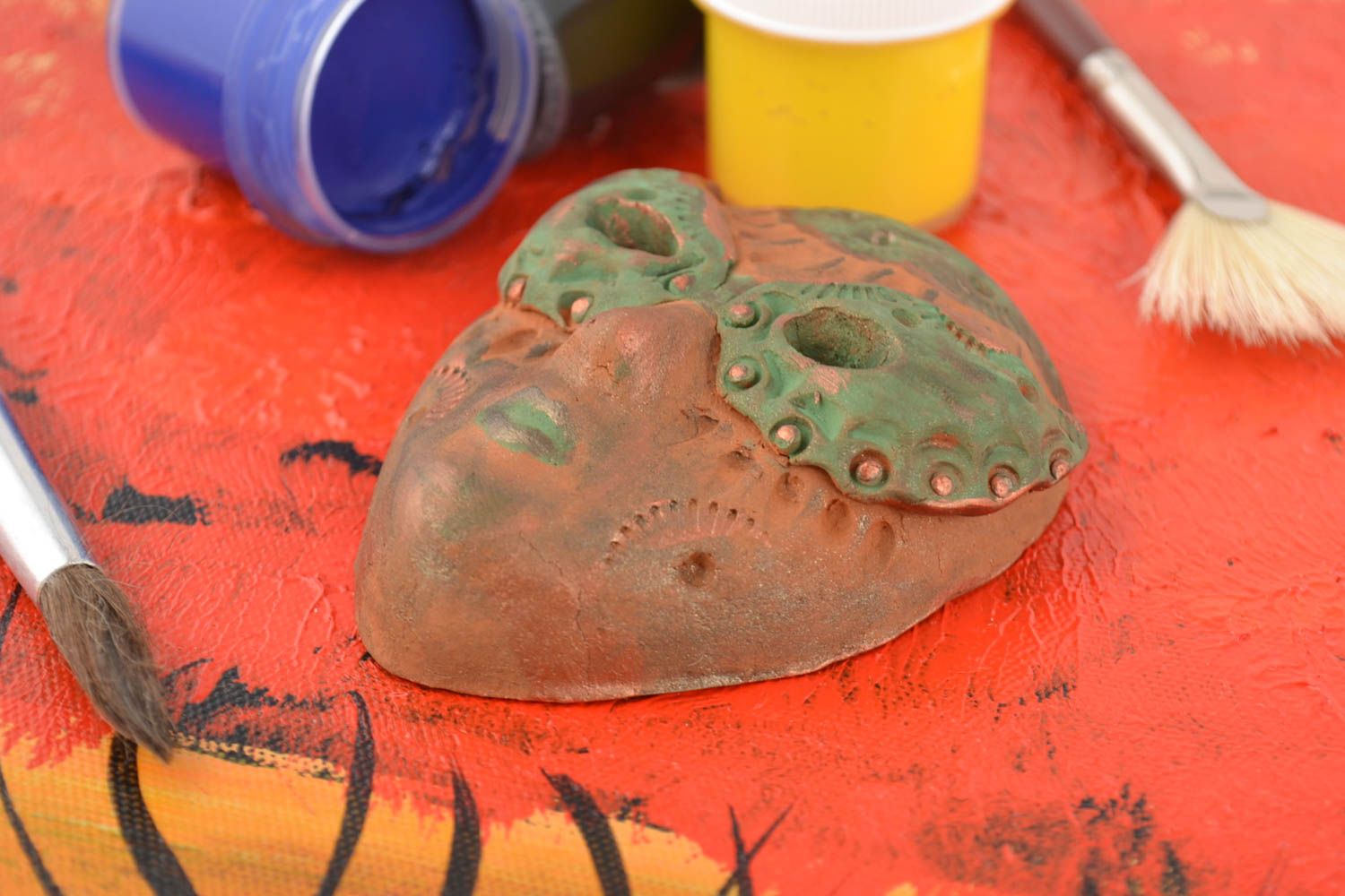 Handmade interesting painted wall pendant carnival mask made of clay  photo 1