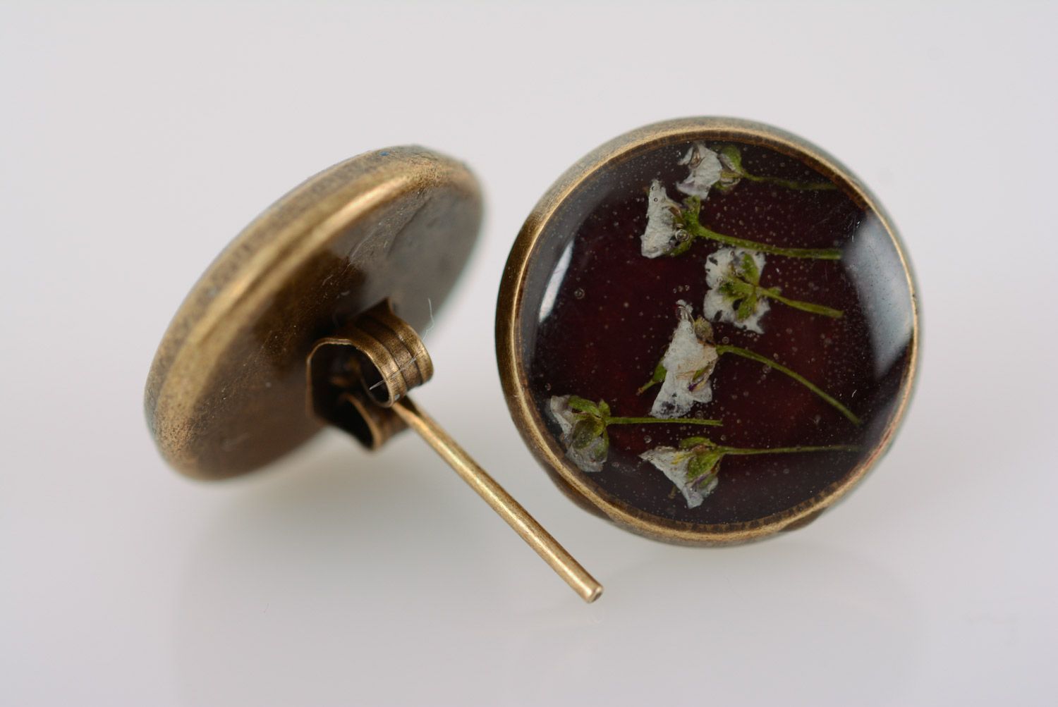 Small flat round dark homemade stud earrings with dried flowers in epoxy resin  photo 2
