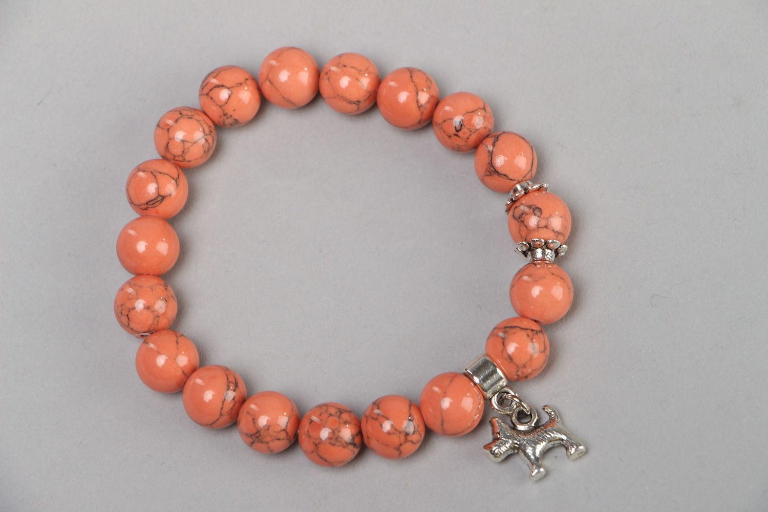 Cute handmade stretch wrist bracelet with natural coral beads and metal charm  photo 1