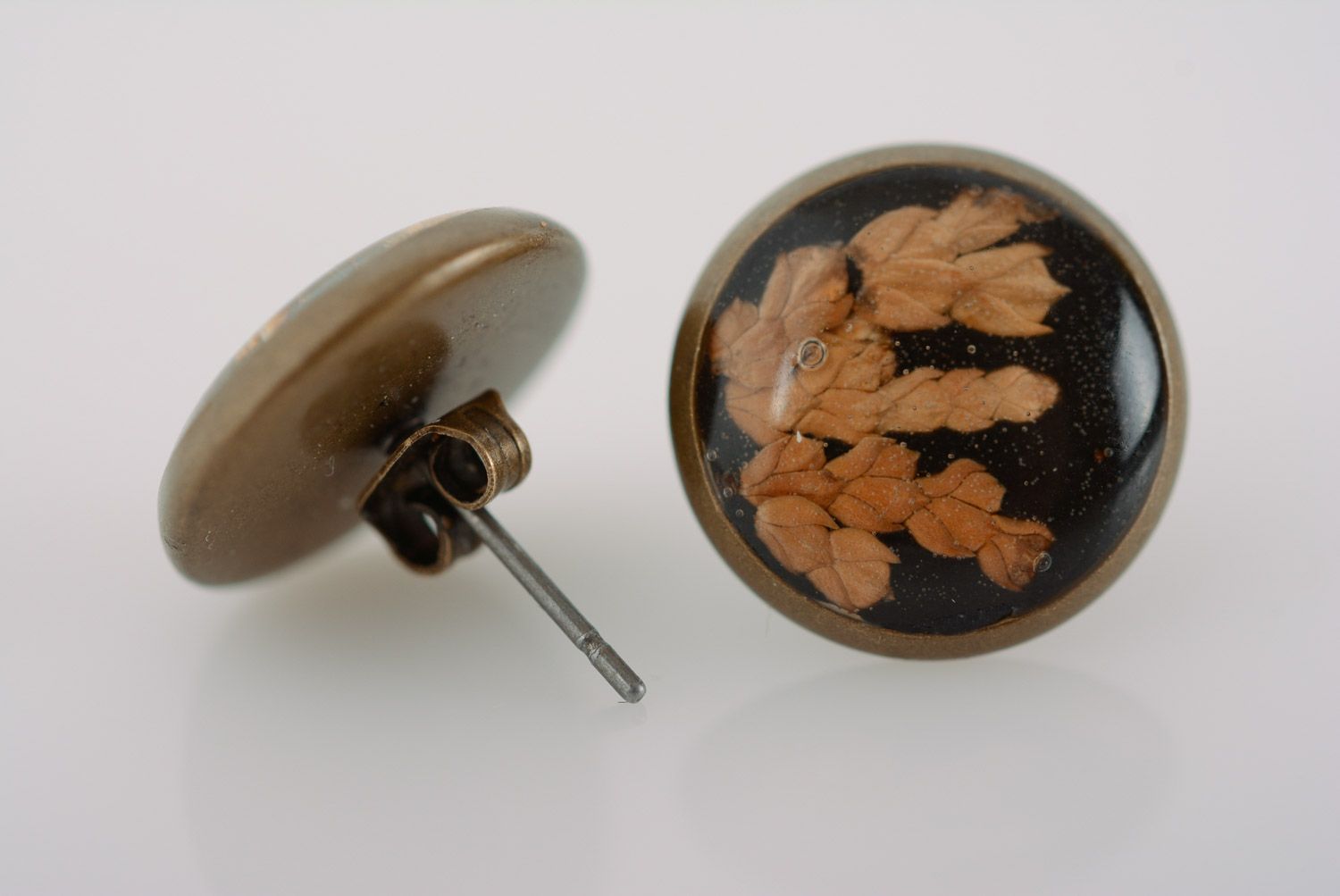 Small round homemade black stud earrings with dried flower in epoxy resin photo 5