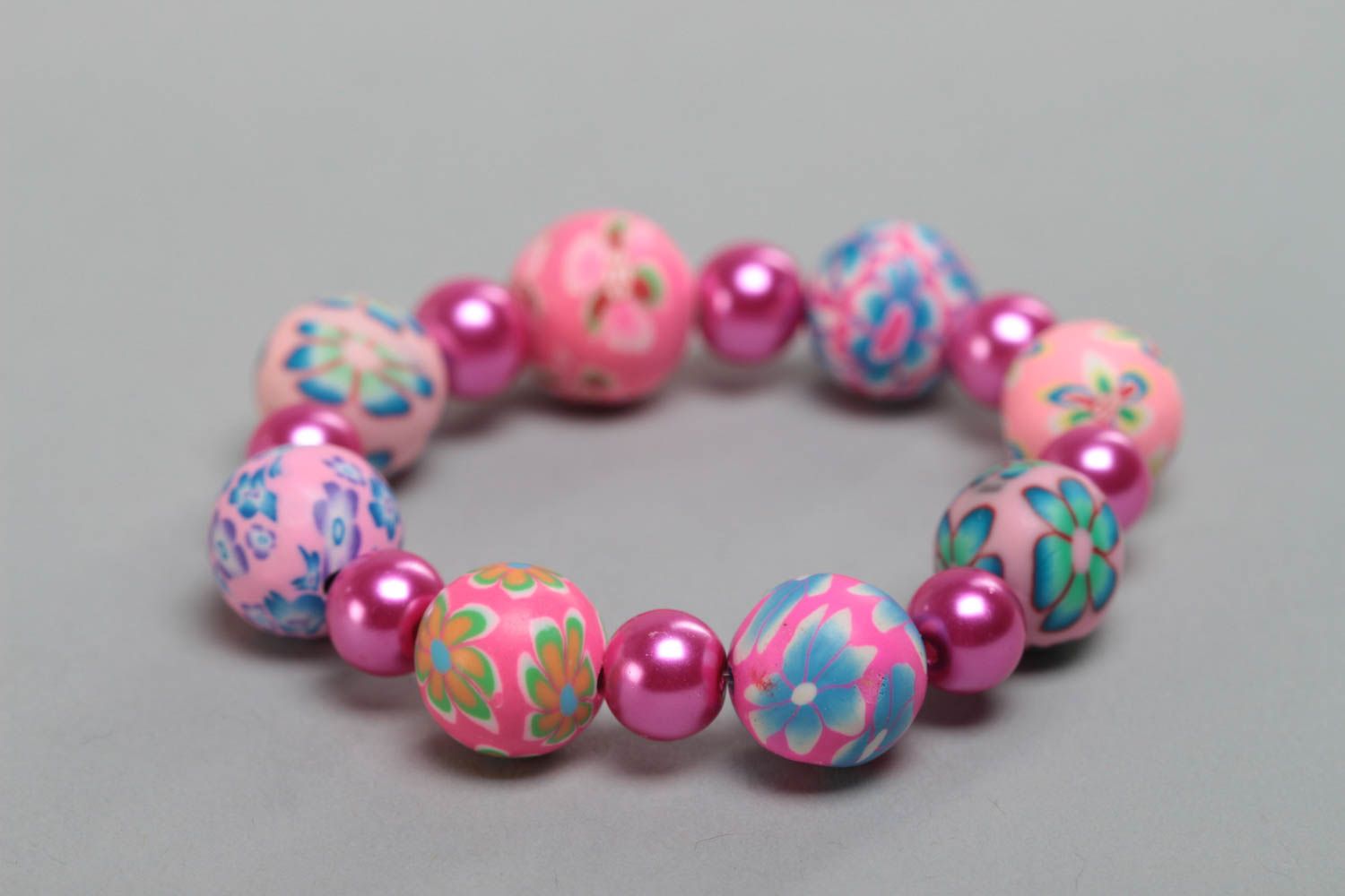 Colorful pink handmade children's plastic bracelet with beads photo 3