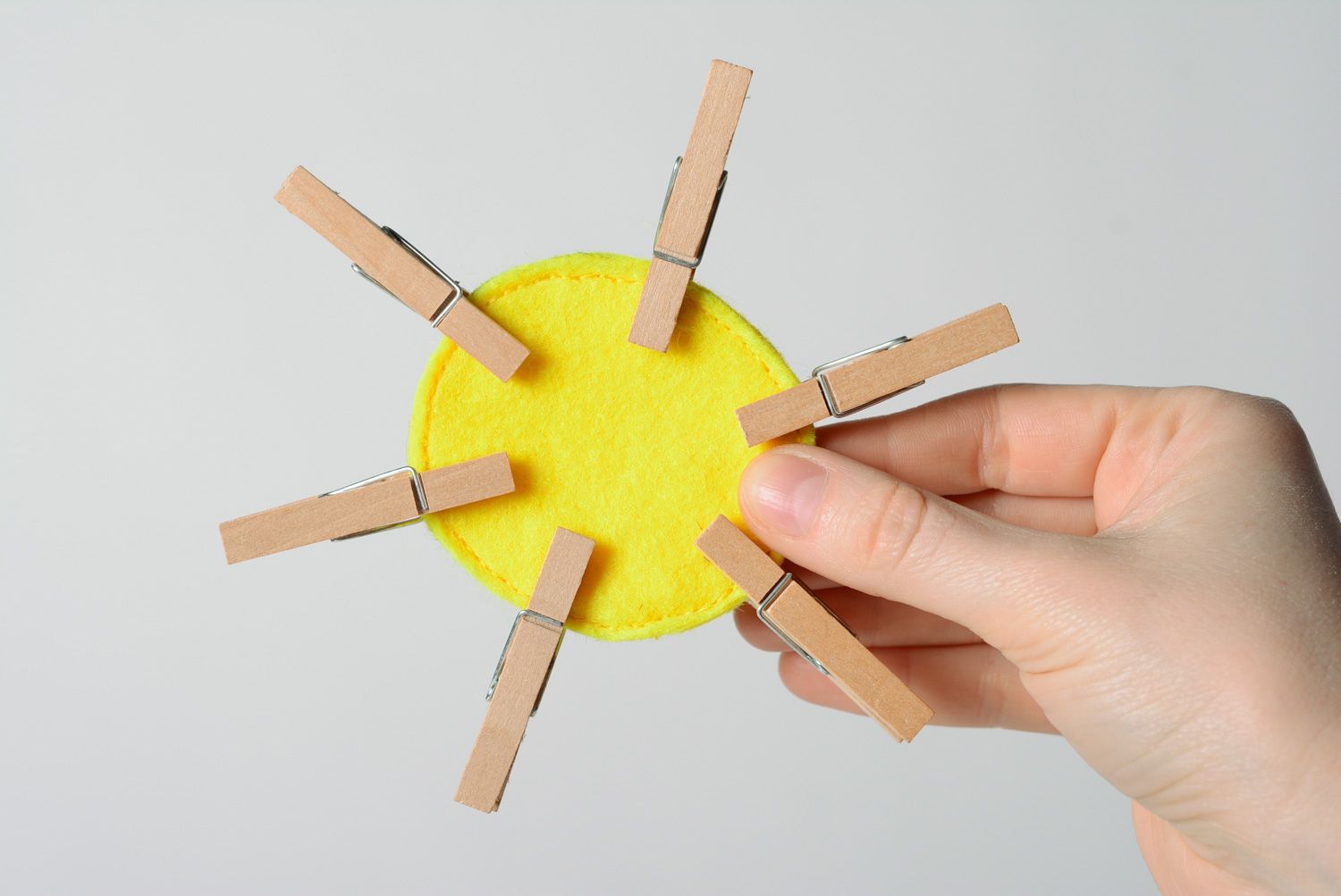 Bright yellow handmade educational toy sewn of felt with clothes pins Sun photo 1