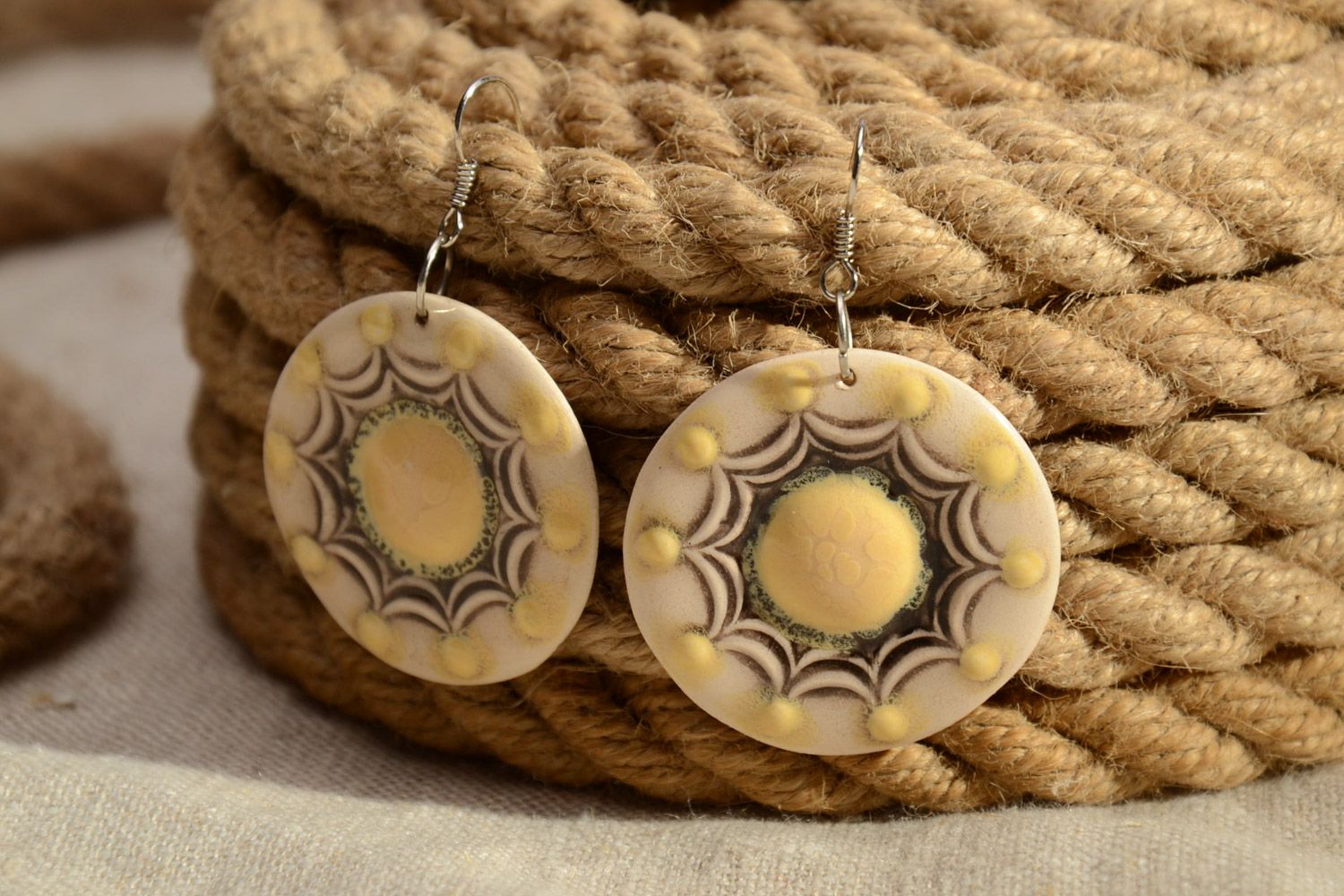 Handmade beige ceramic dangle earrings of round shape painted with enamels photo 1