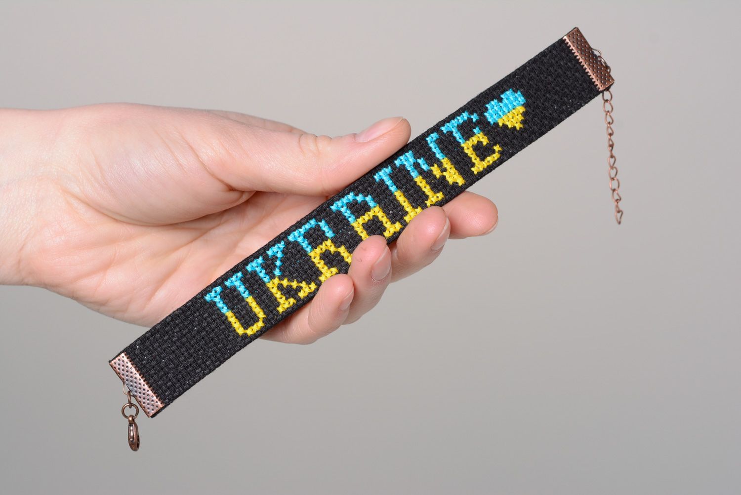 Handmade designer bracelet with embroidered lettering Ukraine on black background photo 4