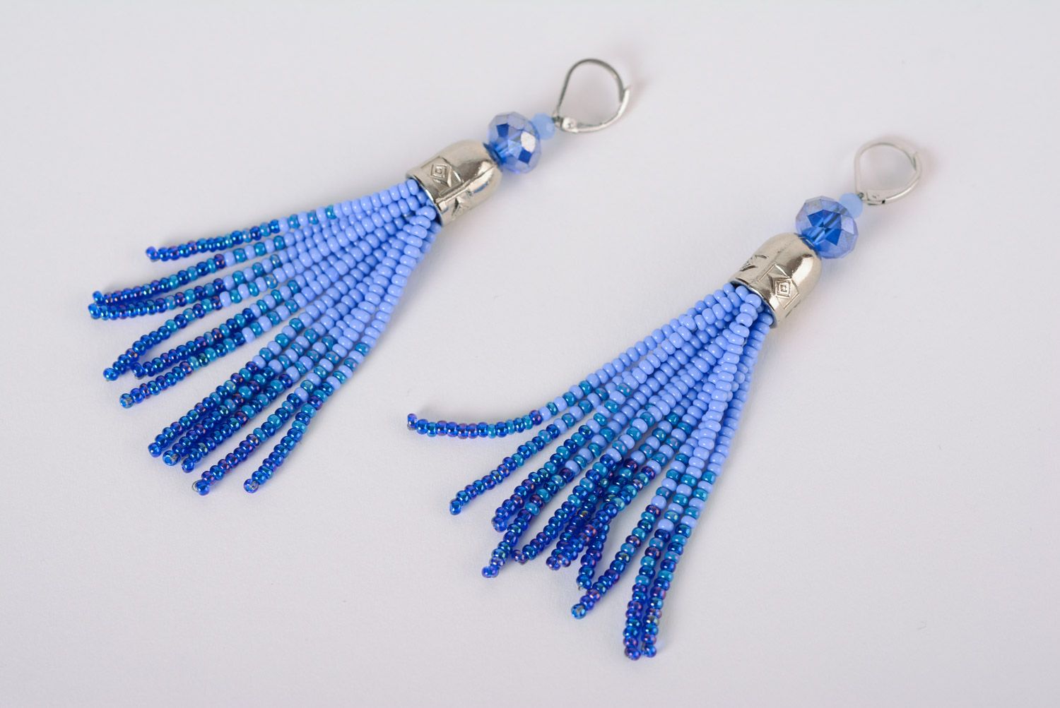 Beautiful women's handmade dangle beaded earrings in blue color palette photo 1