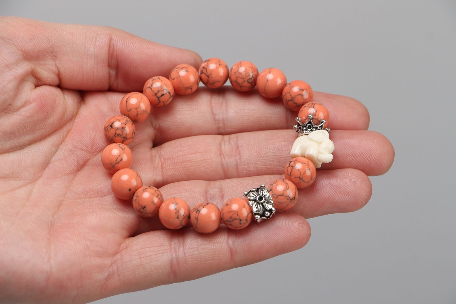 Handmade stretch wrist bracelet with natural coral beads and elephant figurine photo 3