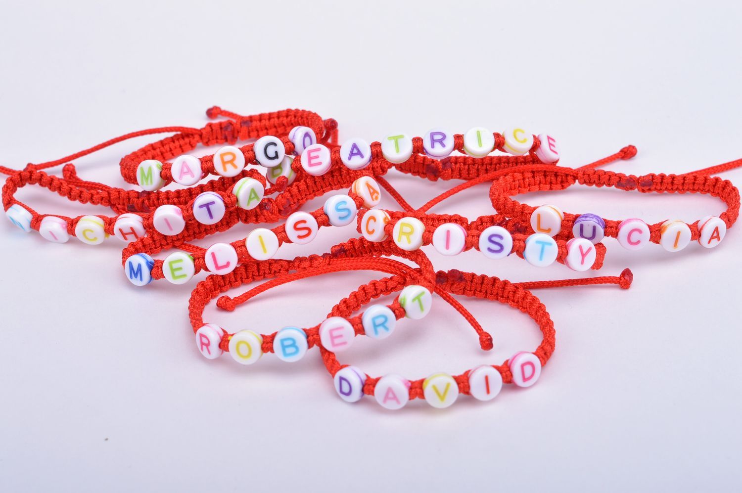 Red handmade woven wrist bracelet with name letters and ties photo 4