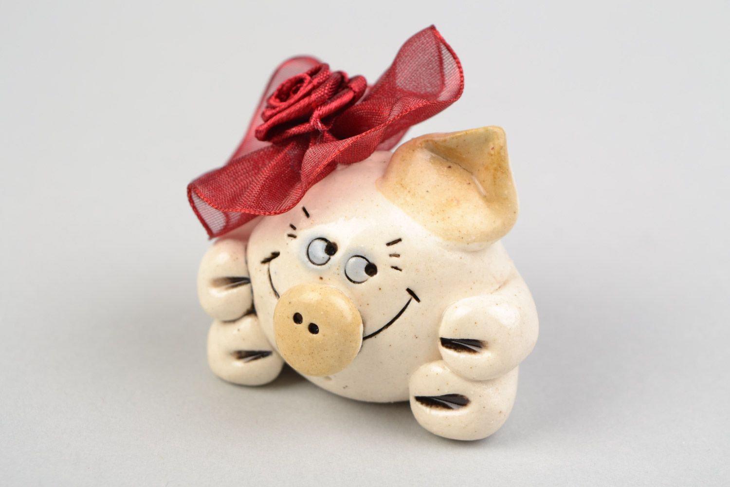 Funny small handmade porcelain statuette of pig with bow for decor photo 1