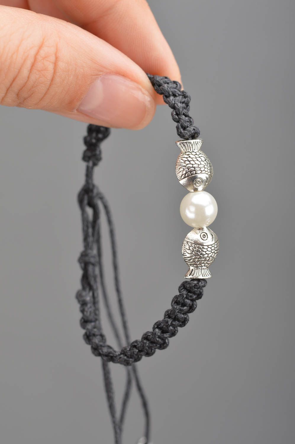 Thin black woven wrist bracelet made of lace with white bead and fittings photo 3