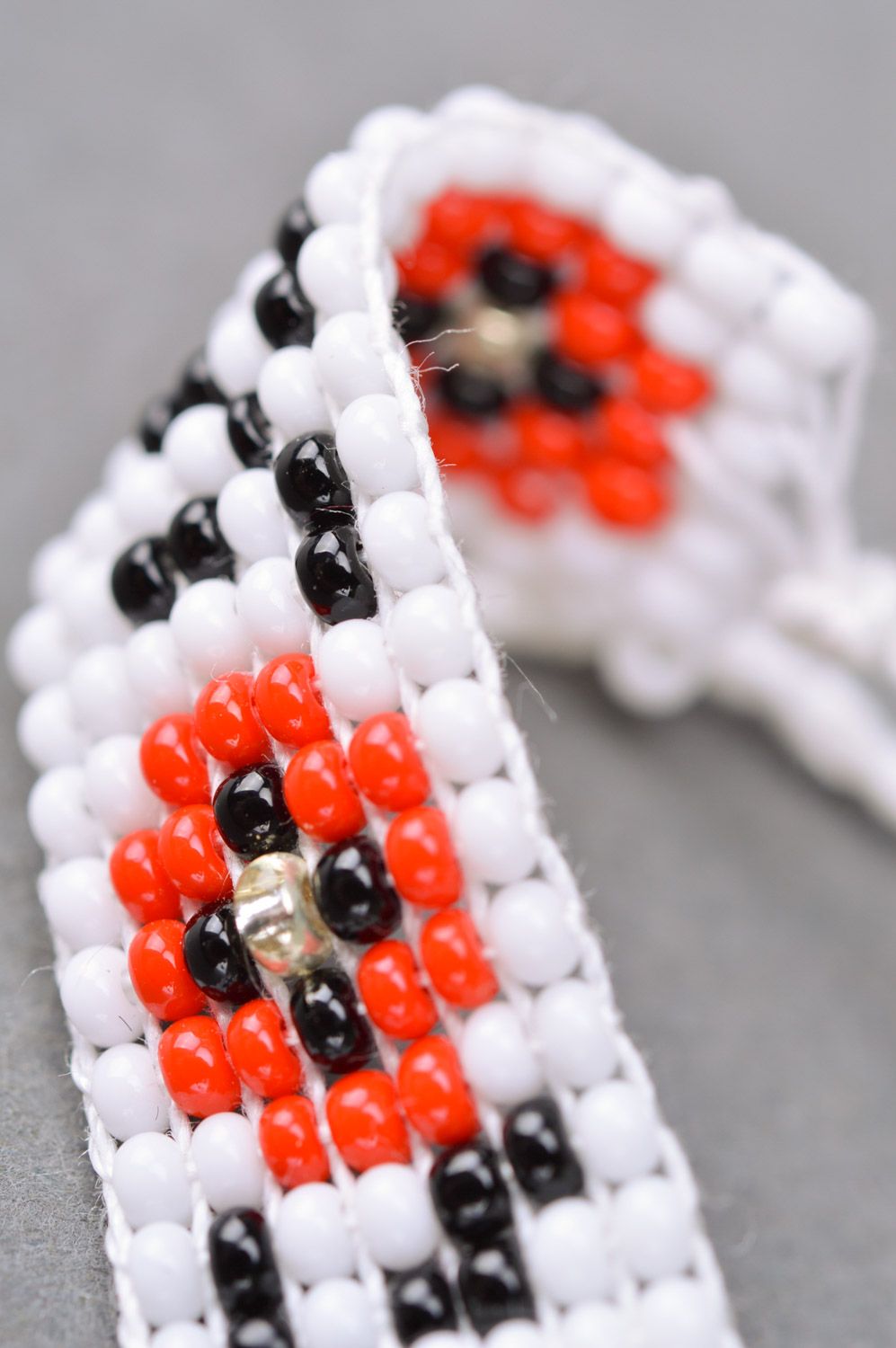 Handmade wrist bracelet woven of black white and red beads with ethnic ornament photo 4