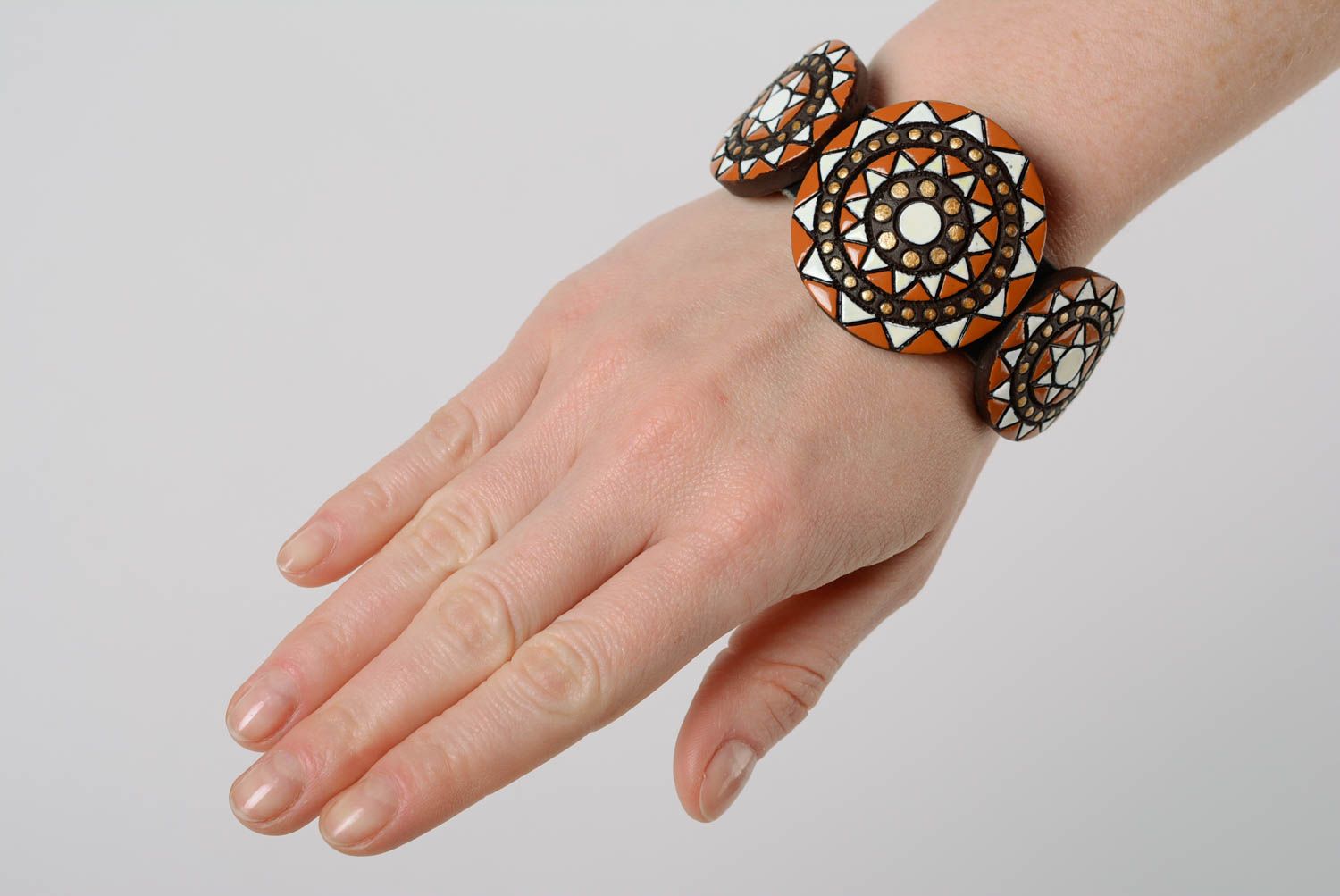 Handmade designer ornamented clay bracelet painted with enamel and equipped with leather strap photo 3