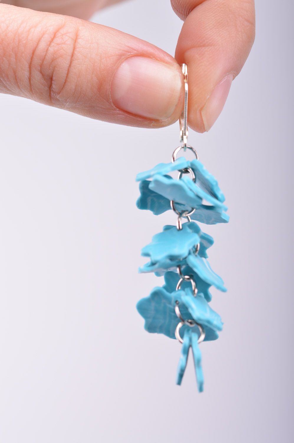 Handmade women's polymer clay flower earrings with charms in the shape of snowflakes of blue color  photo 1