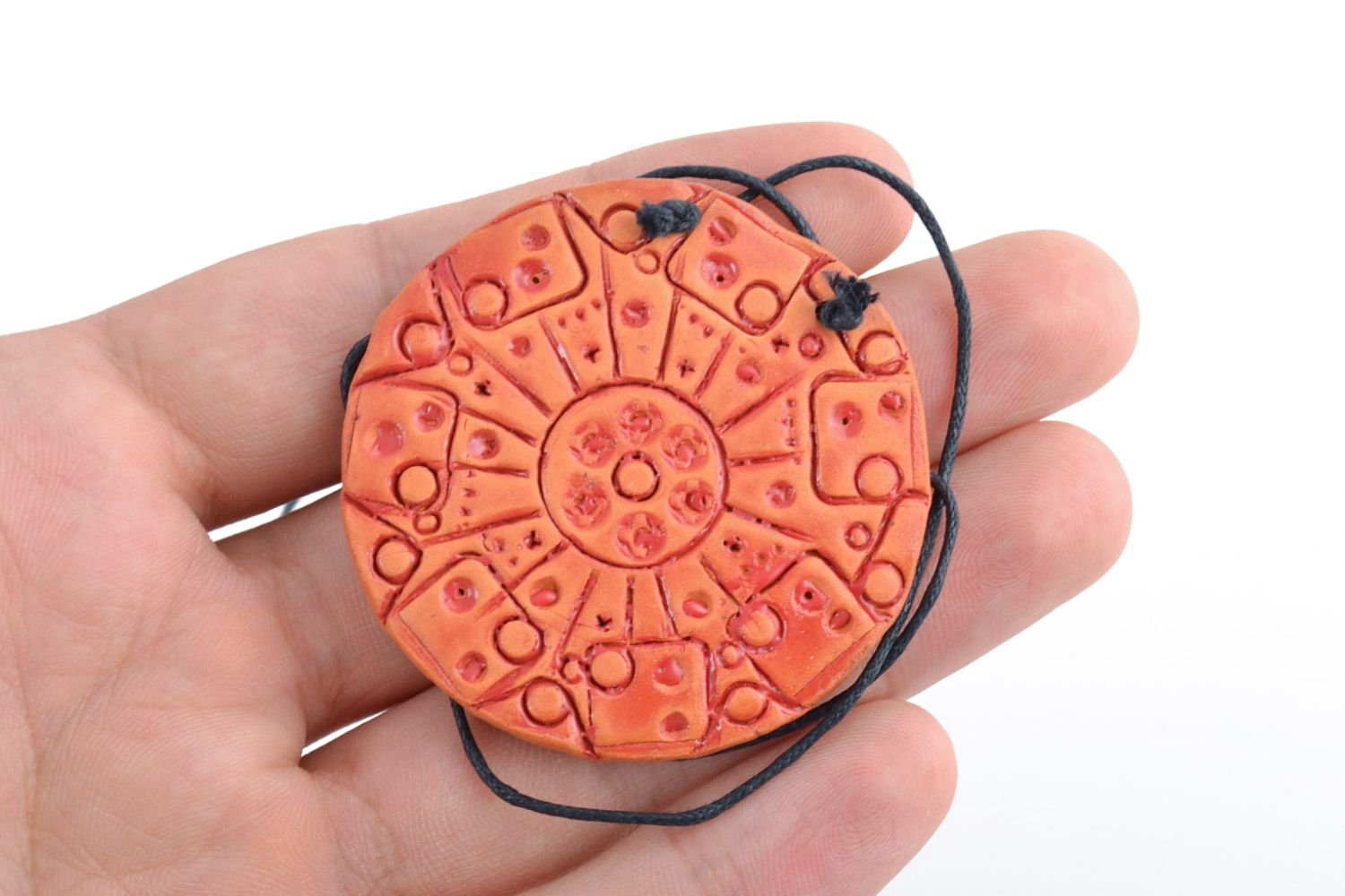 Handmade bright orange ceramic pendant of round shape with ornament on cord photo 2