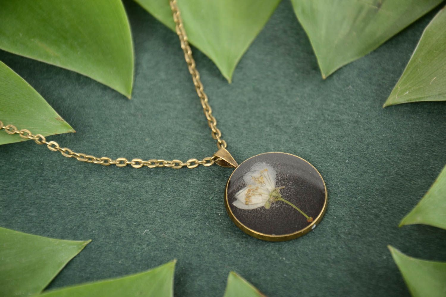 Handmade dark round pendant with natural flowers in epoxy resin without chain photo 1