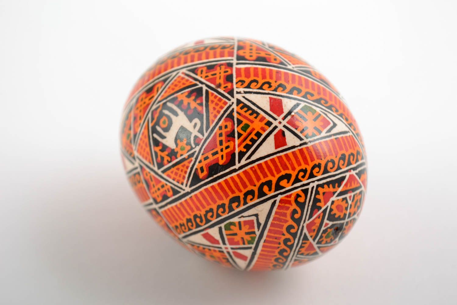 Beautiful handmade painted orange Easter egg with Slavic symbolics photo 3