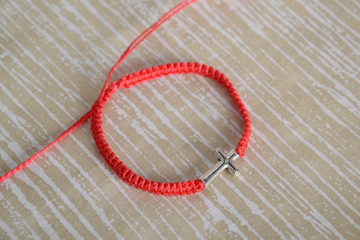 Handmade red friendship wrist bracelet woven of threads with metal cross photo 1