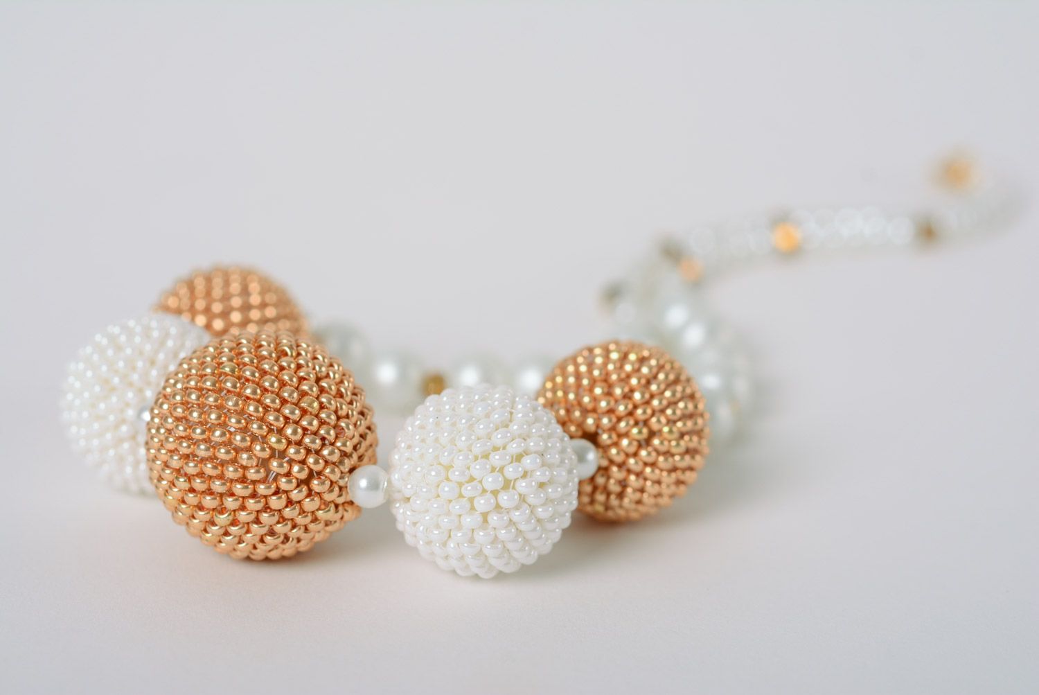 Tender handmade necklace with five balls woven of white and golden beads  photo 2