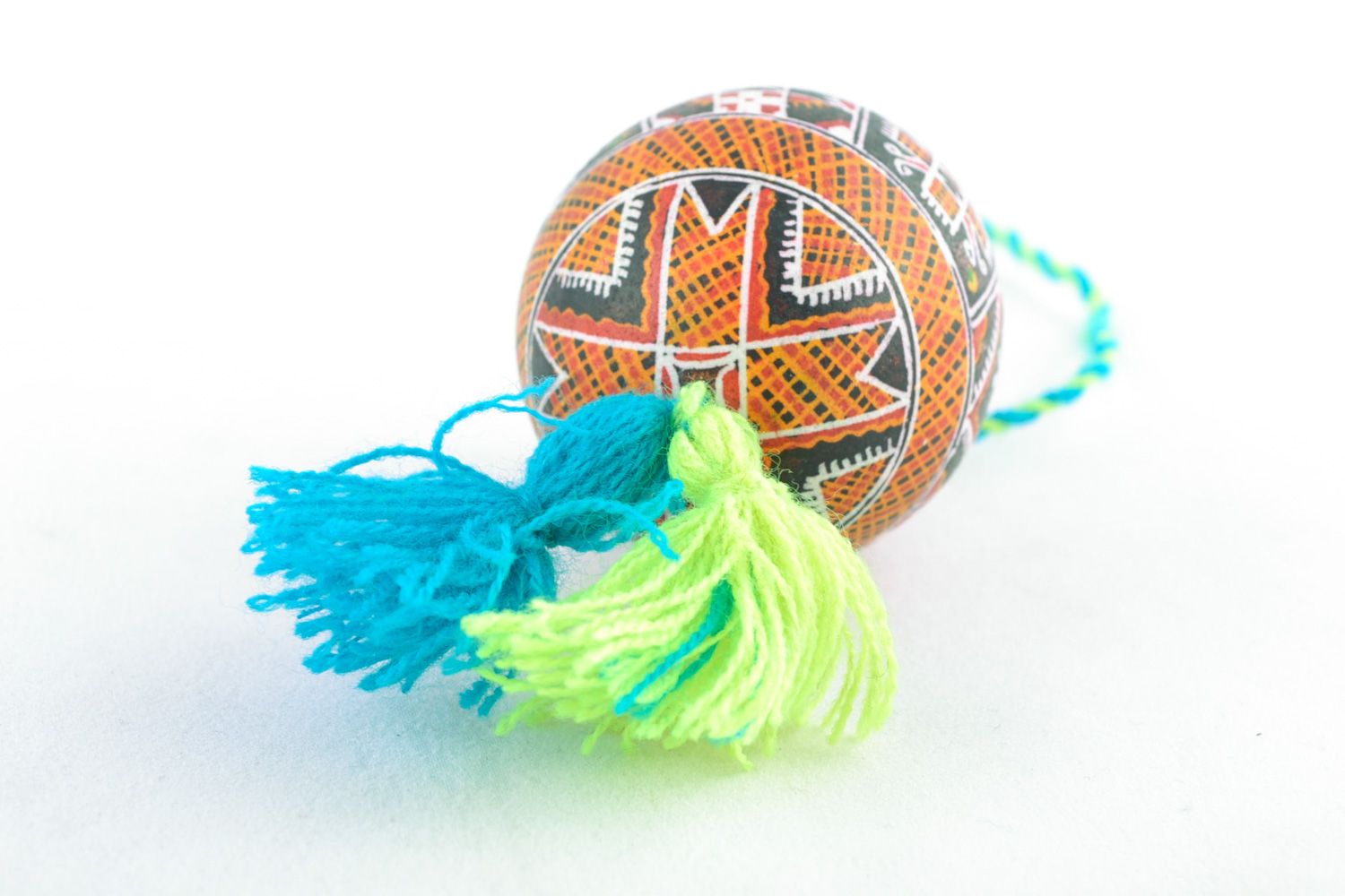 Handmade hanging Easter egg painted using wax technique with yellow and blue tassels photo 3