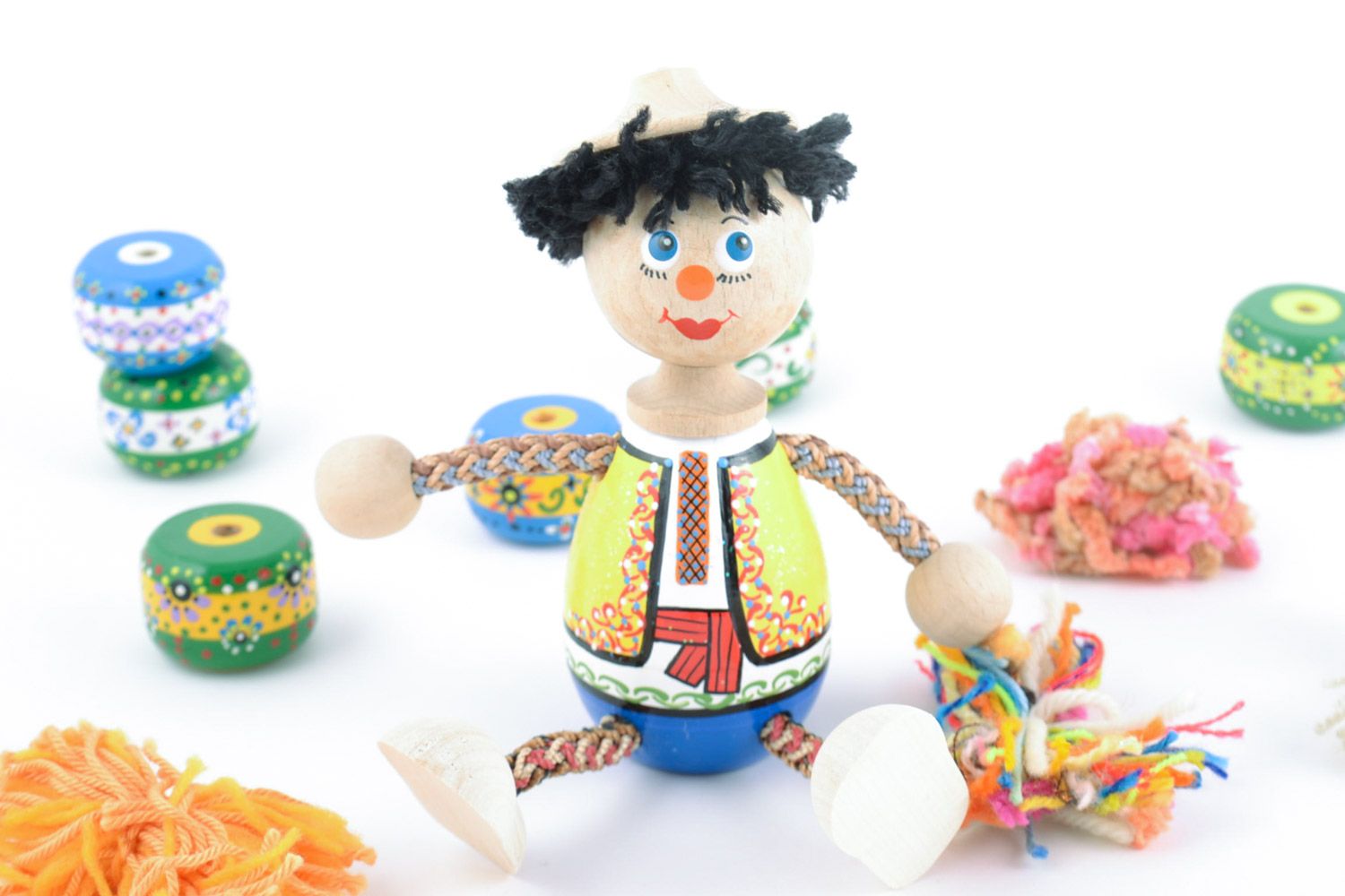 Handmade wooden eco toy in the shape of boy painted in ethnic style for kids photo 1