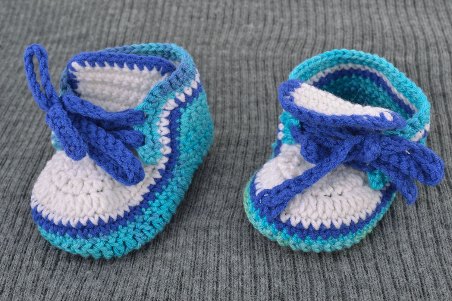 Handmade knitted wool baby booties in blue color palette photo 1