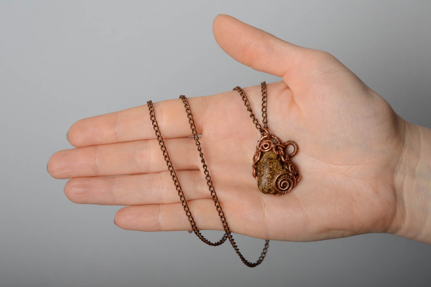 Copper pendant with natural bronzite stone photo 4