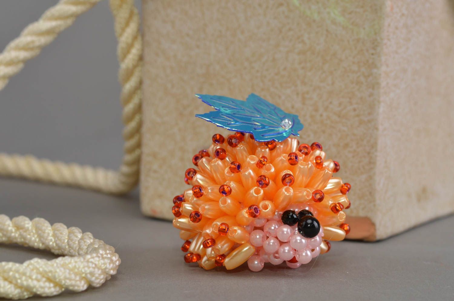 Small homemade designer beautiful beaded figurine of yellow hedgehog with leaf photo 1