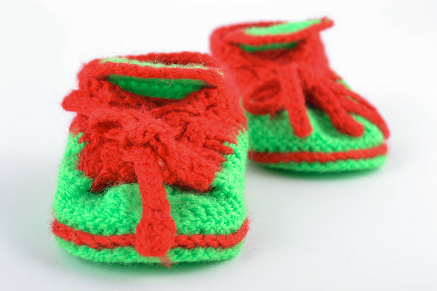 Red and green handmade knitted warm baby booties in the shape of shoes photo 5