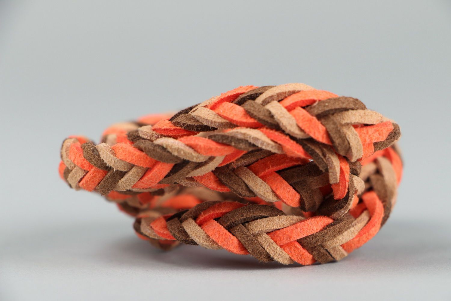 Suede bracelet of orange and brown colors photo 1