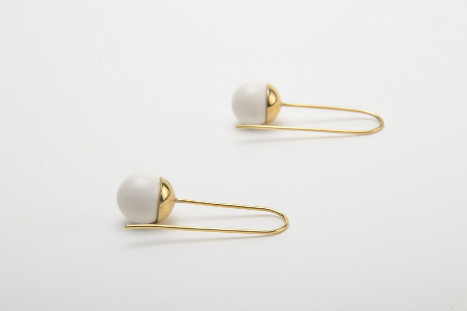 Stylish white handmade ceramic ball earrings with brass frame photo 4