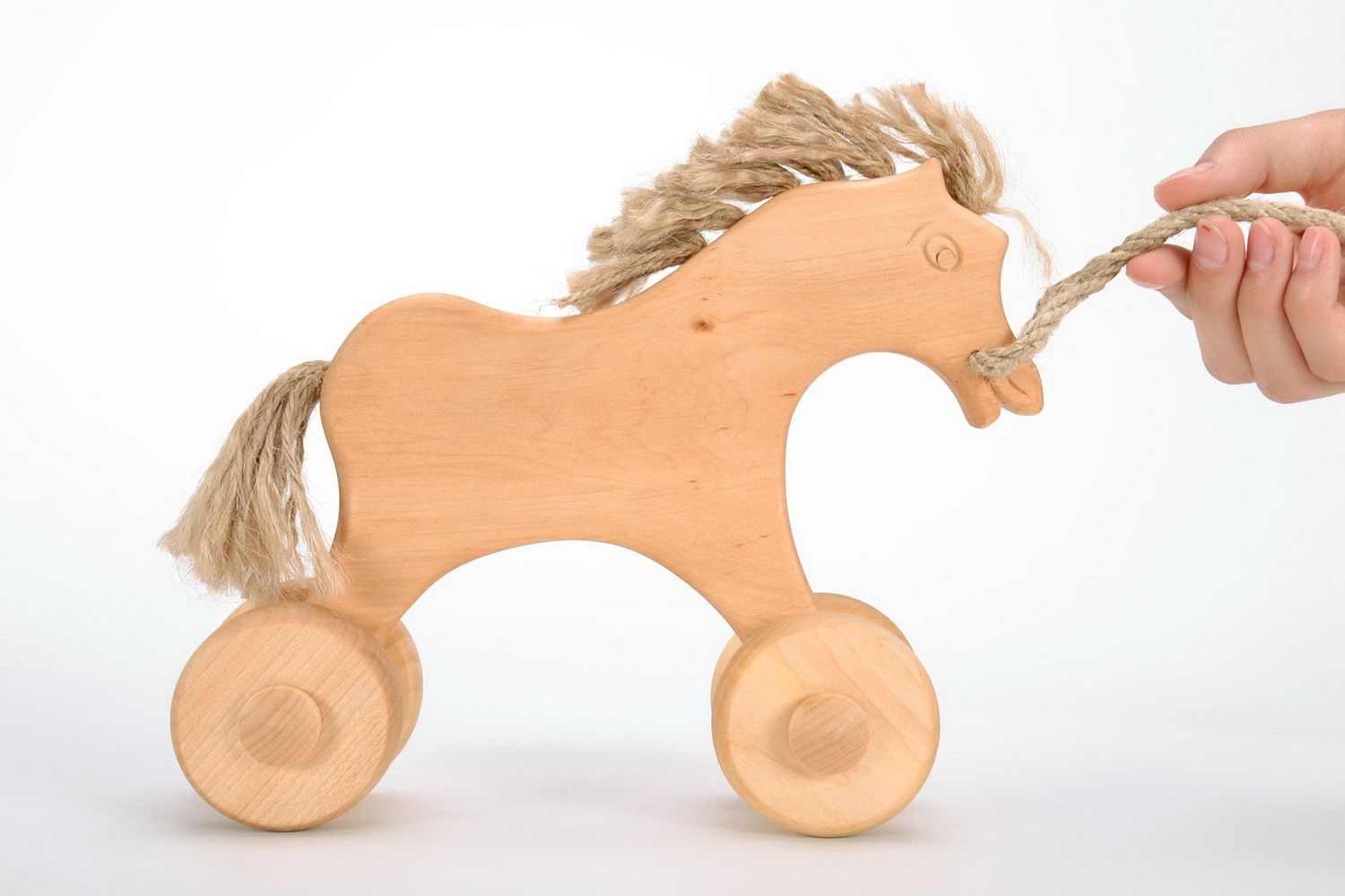Holzspielzeug Pferd mit Rädern foto 2