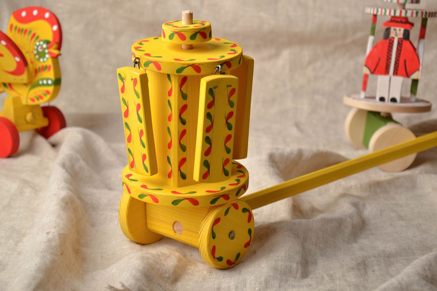 Painted wooden toy with wheels  photo 1