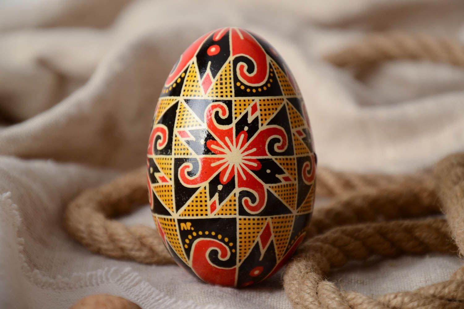 Homemade decorative Easter egg traditional pysanka painted in contrast colors photo 1