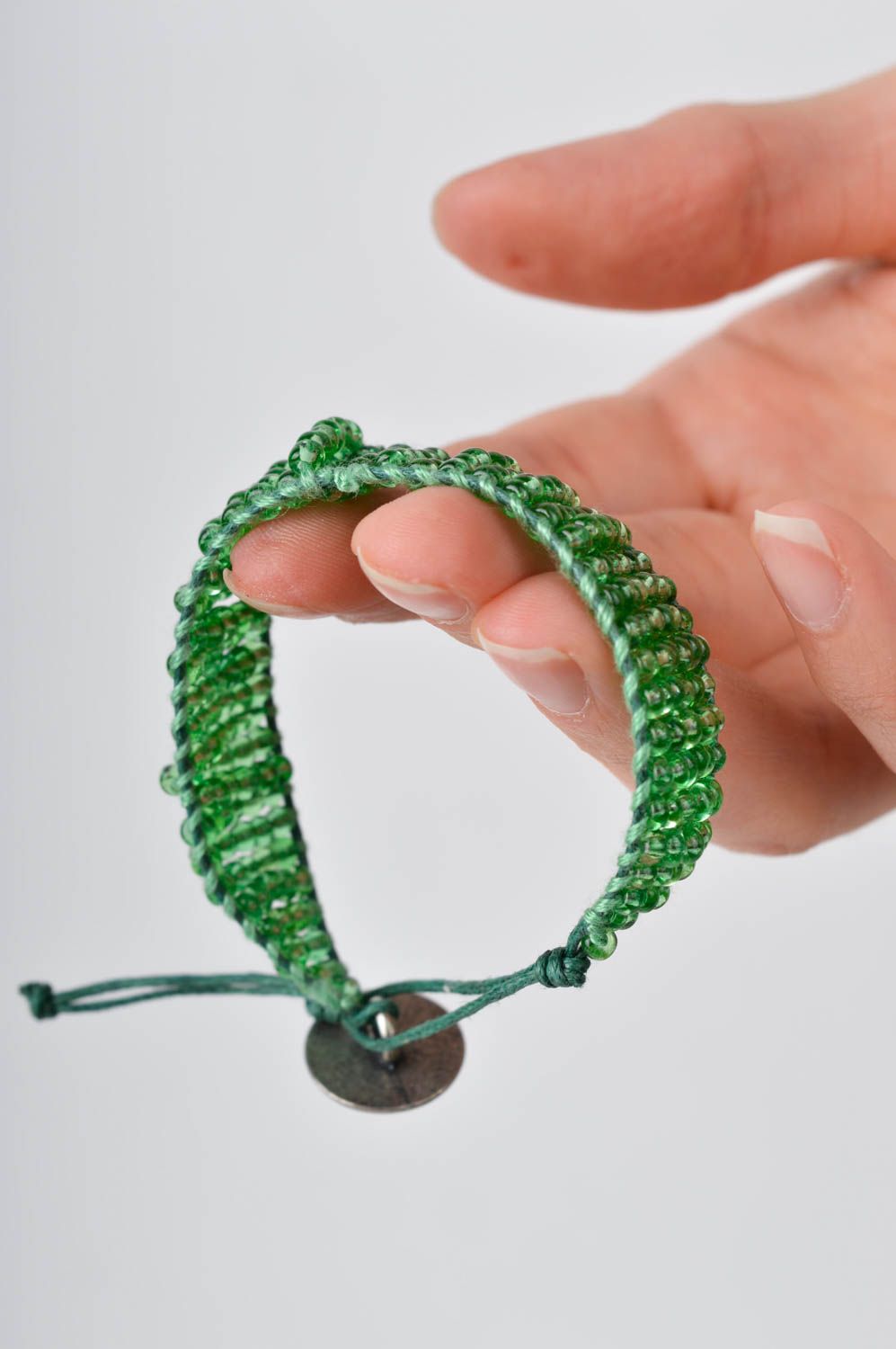 Light green homemade strand beaded bracelet with bronze token photo 2