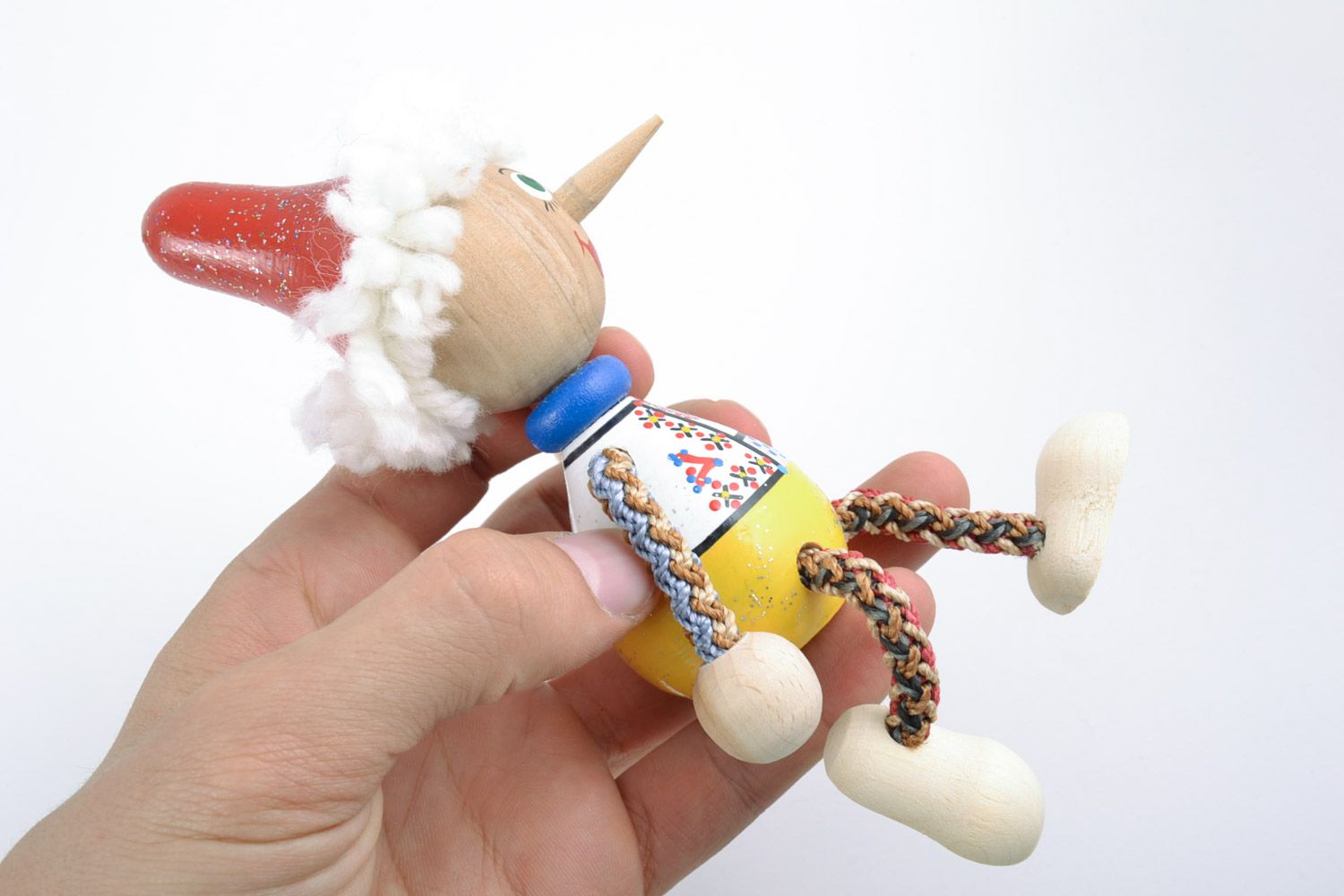 Handmade small painted wooden toy in the shape of Pinocchio for children  photo 2