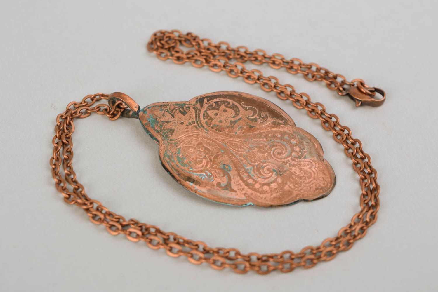 Copper pendant on long chain created using patina coating and etching techniques photo 4
