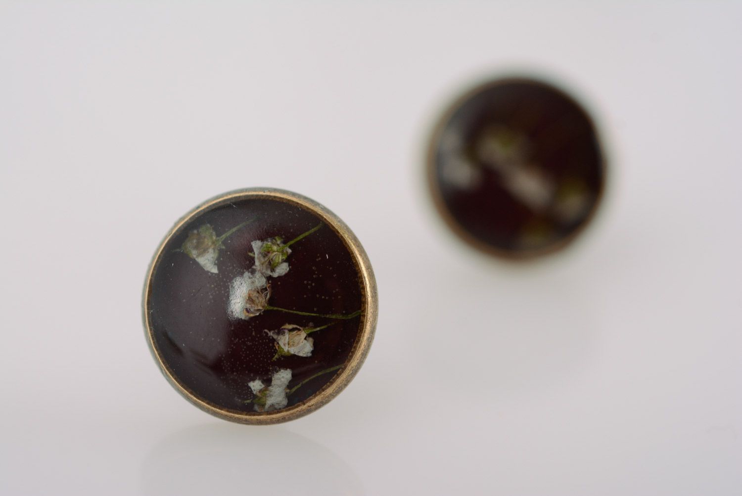 Small flat round dark homemade stud earrings with dried flowers in epoxy resin  photo 5