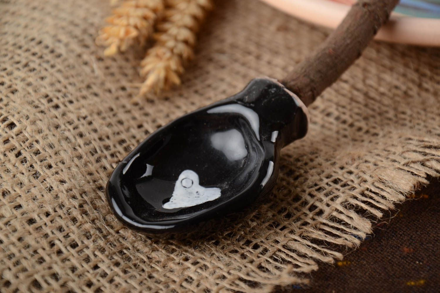Black handmade designer clay spoon with apricot wood handle photo 1
