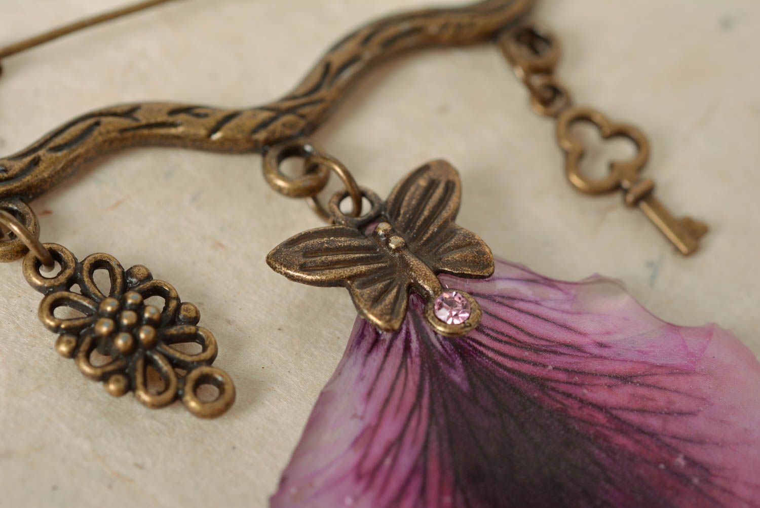 Handmade designer metal figured pin brooch with violet petal in epoxy resin photo 3