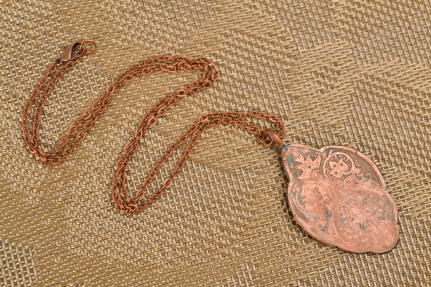 Copper pendant on long chain created using patina coating and etching techniques photo 1