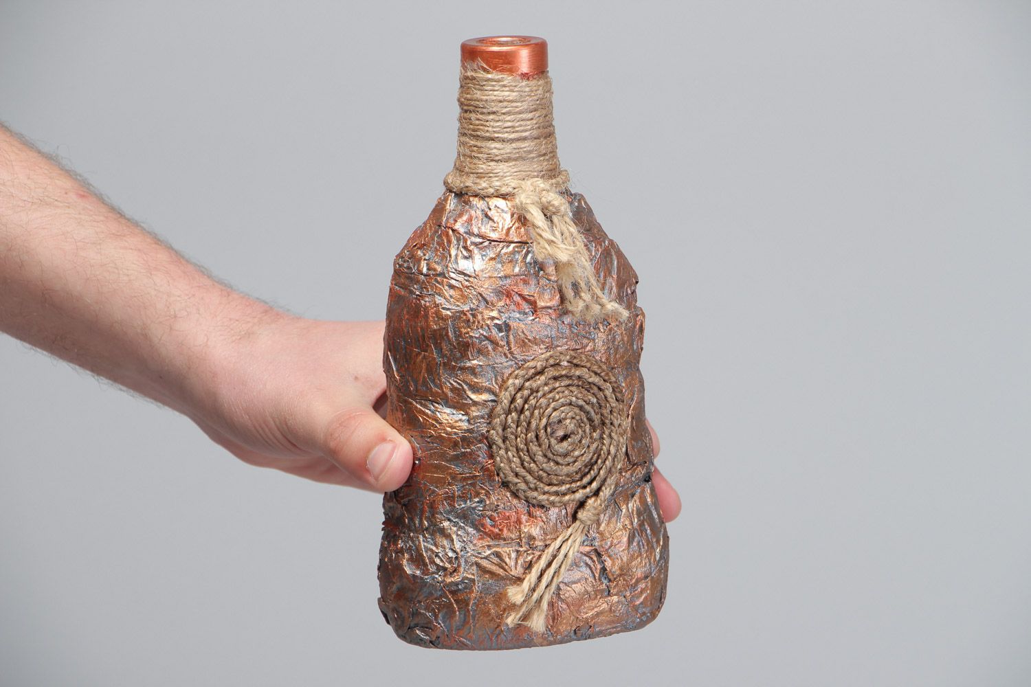 Handmade decorative glass bottle covered with paper and cord in ethnic style photo 5