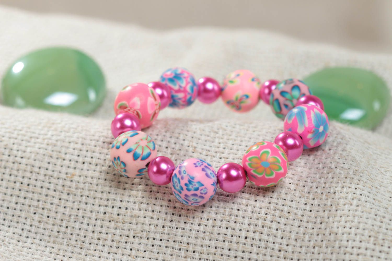 Colorful pink handmade children's plastic bracelet with beads photo 1