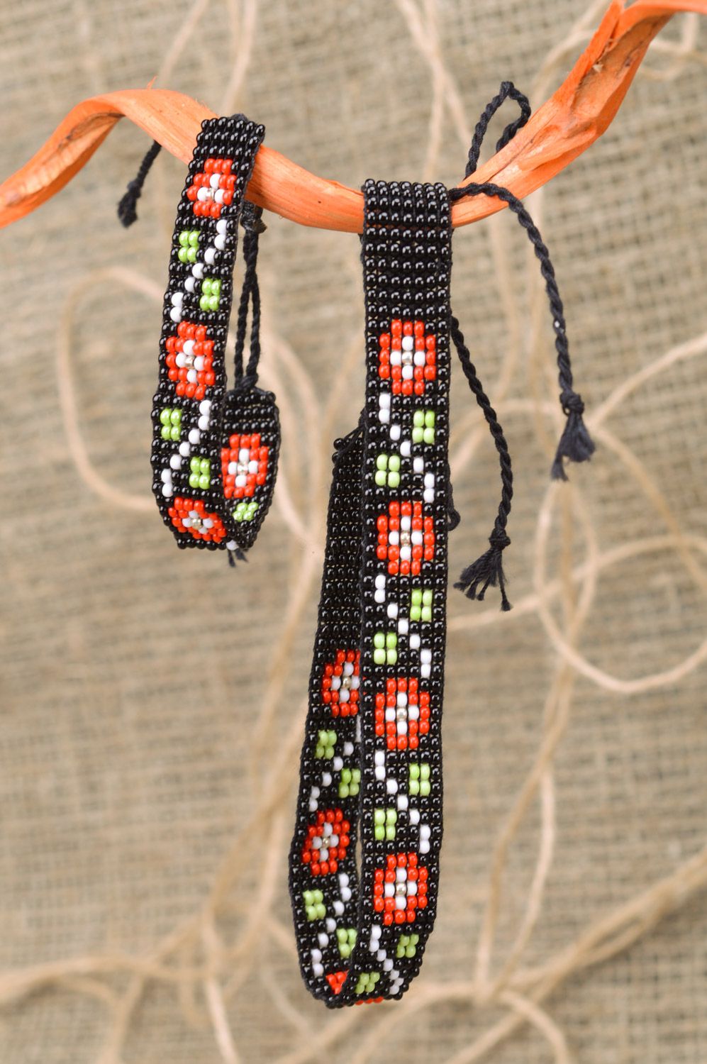 Handmade bracelet with ties and necklace woven of Czech beads with red flowers photo 1