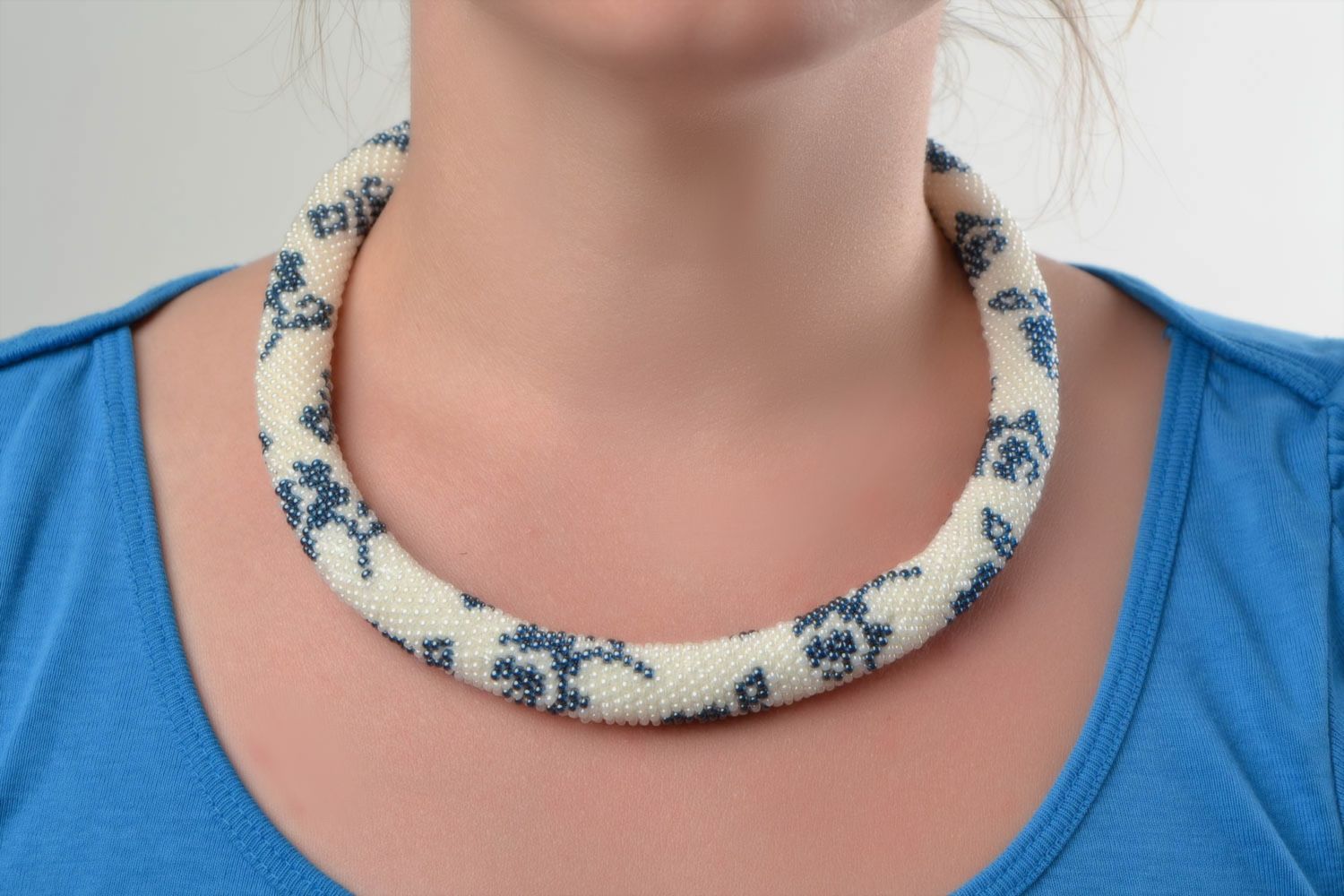 Beautiful handmade beaded cord necklace white with blue patterns photo 1