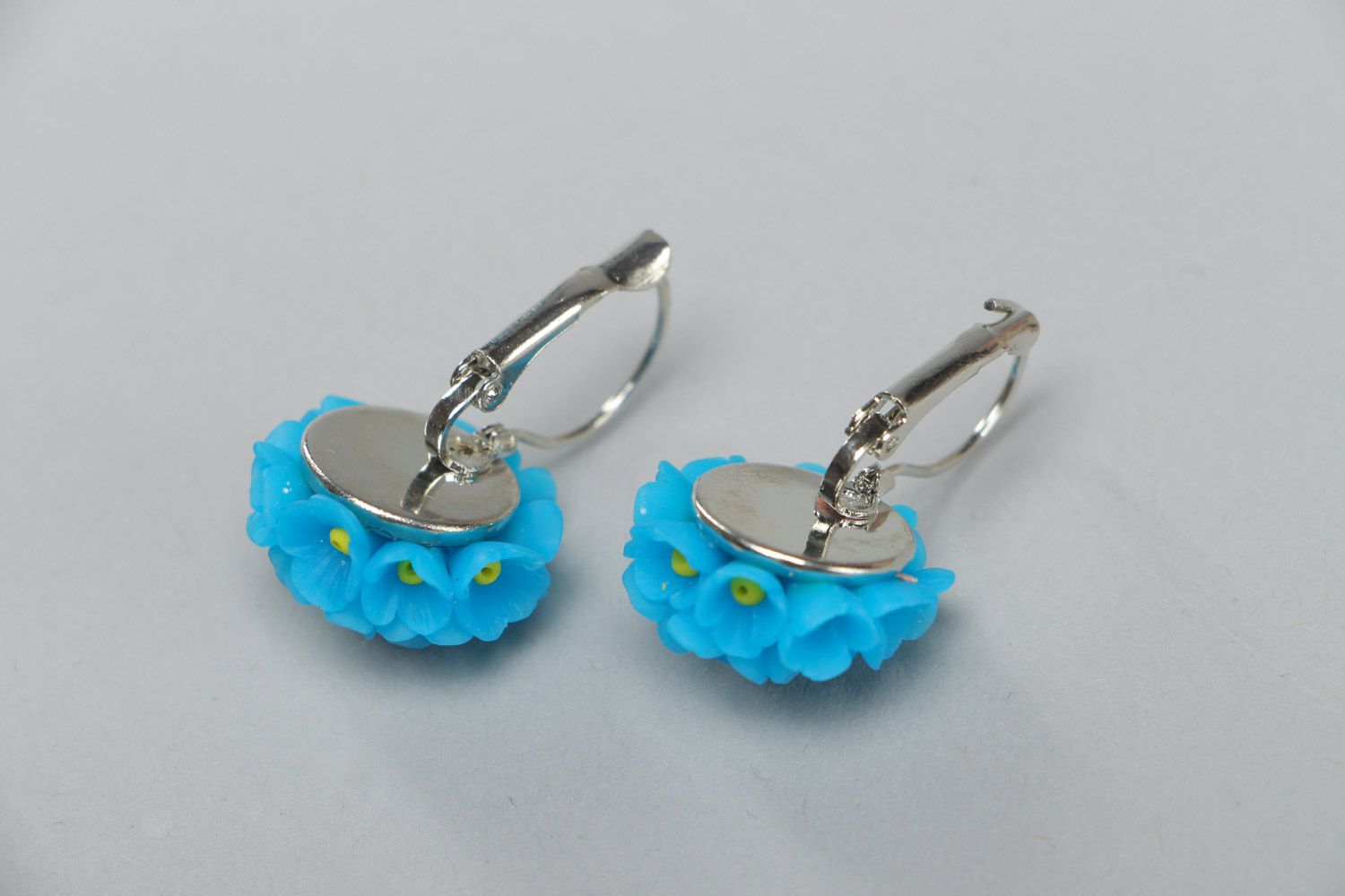 Small handmade polymer clay dangling earrings in the shape of blue flowers photo 4