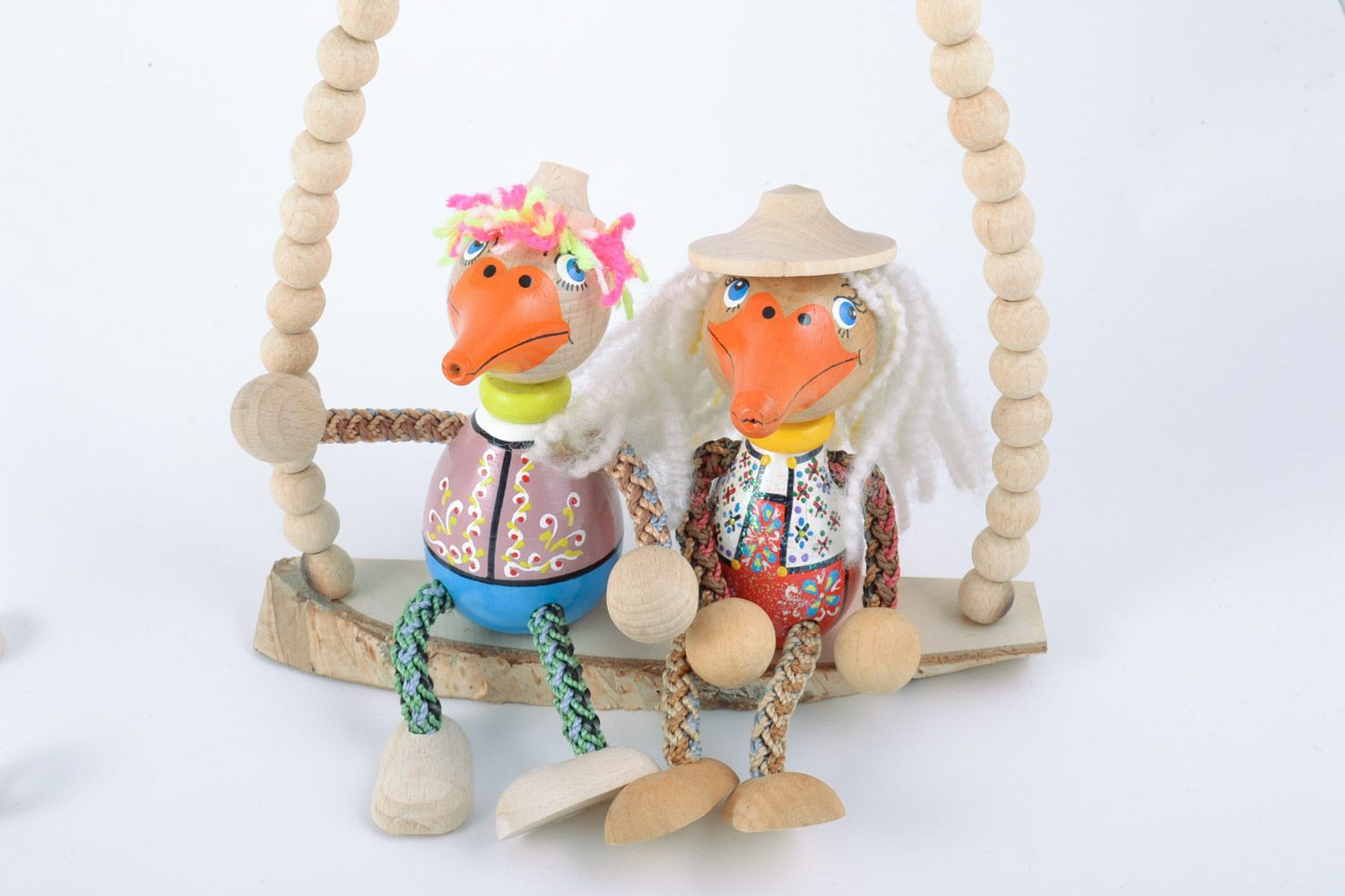 Handmade painted wooden eco toys in the shape of 2 funny ducks sitting on swing photo 3