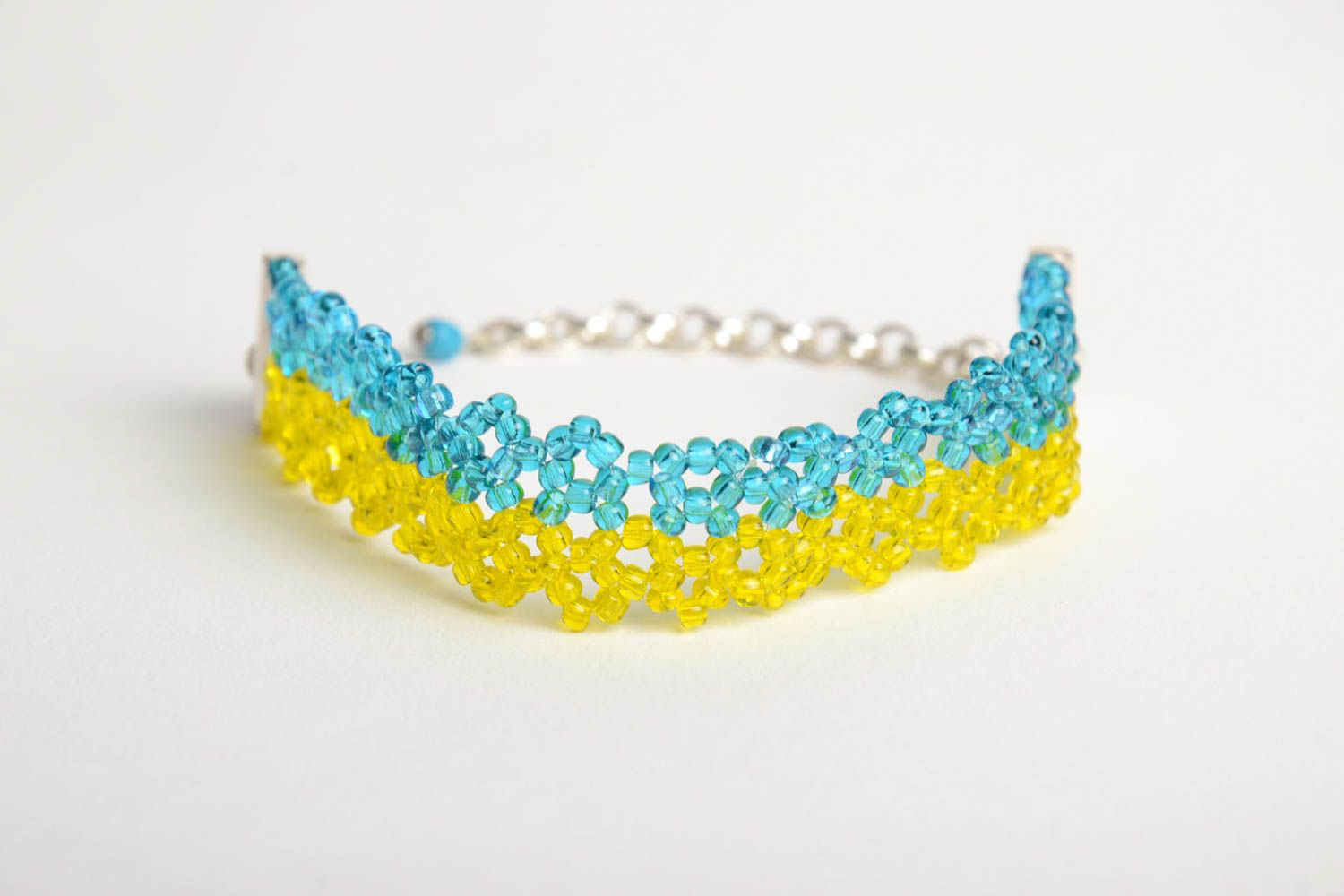 Handmade wrist bracelet crocheted of yellow and blue beads with metal chain photo 3