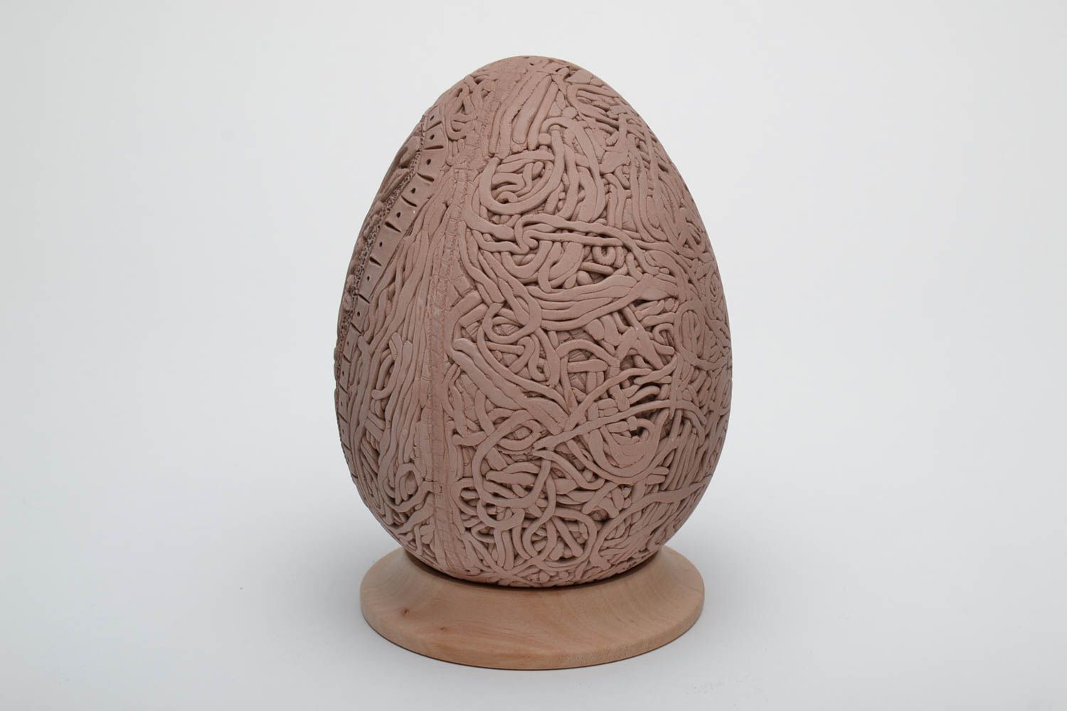 Ceramic Easter egg with elegant molded elements and wooden holder photo 4