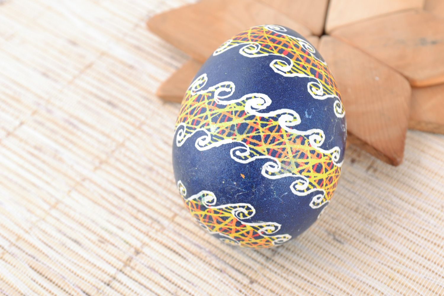 Handmade decorative Easter egg painted with acrylics on blue background photo 1