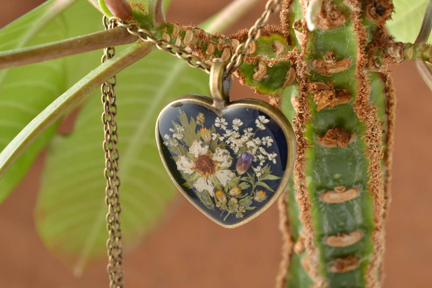 Heart shaped pendant with real flowers coated with epoxy  photo 1